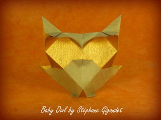Origami owl with golden eyes