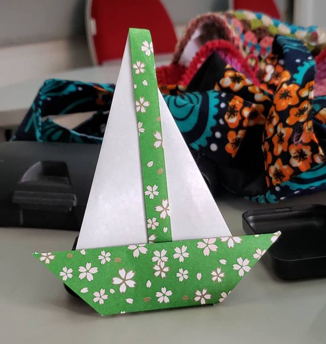 Origami boat with cherry blossom flower paper