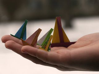 Tiny origami sailboats in Kiev
