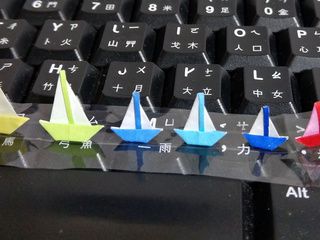 Mini origami sailboats sailing through the Keys