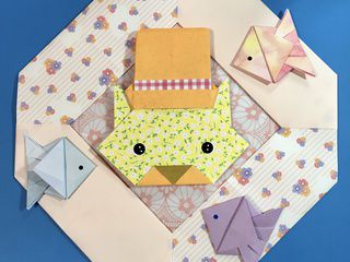Origami cat with hat crown with fishes