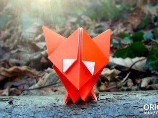 Cute origami fox in the woods