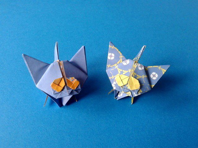 The origami kittens on a blue background.