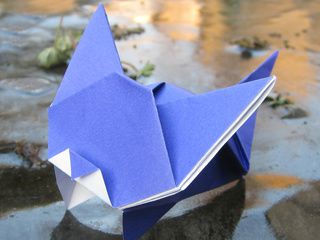 Origami cat playing on icy lake