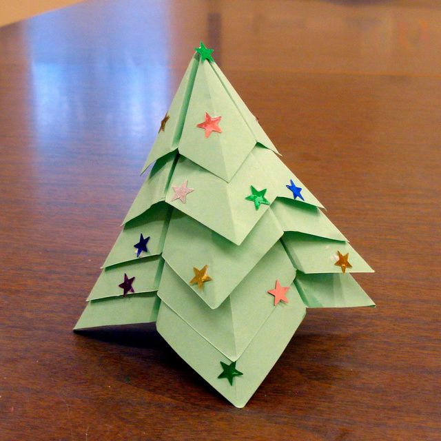 An origami Christmas tree decorated with star stickers.